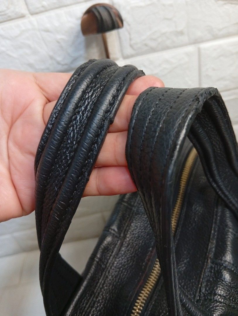 Givenchy Black Leather Nightingale Handbag (Category: Shoulder Bags) located in Las Pinas. Submitted by etoksi1234 (Listing ID 1464198091, Image 3). Description: Pre-loved Givenchy Nightingale bag featuring dual top handles, structured paneling, and embossed 4G logo accents on the handle patches. No sling Included..