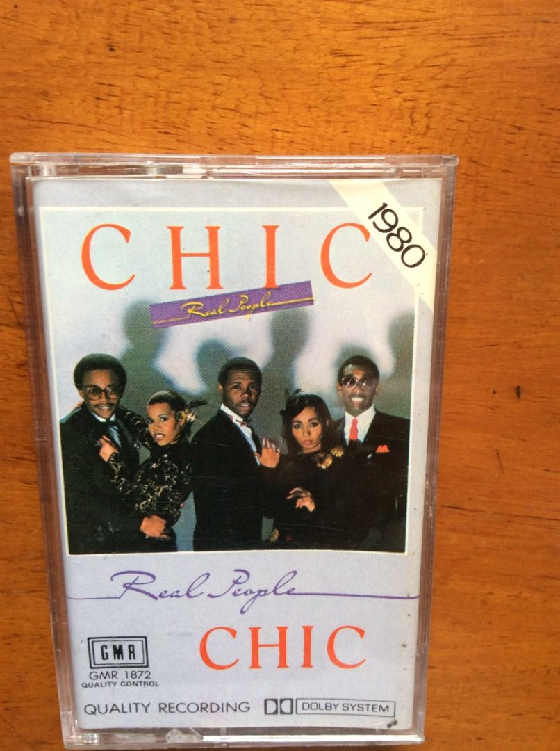 Chic - Real People 1980 Cassette Tape (Category: CDs & DVDs) located in Silang. Submitted by lawrencenorthey (Listing ID 1464141617, Image 1). Description: - Vintage cassette tape from 1980 - Side A Tracks: 'Open Up', 'Real People', 'I Loved You More', 'I Got Protection' - Side B Tracks: 'Rebels Are We', 'Chip Off The Old Block', '26', 'You Can't Do It Along' - Includes original case.