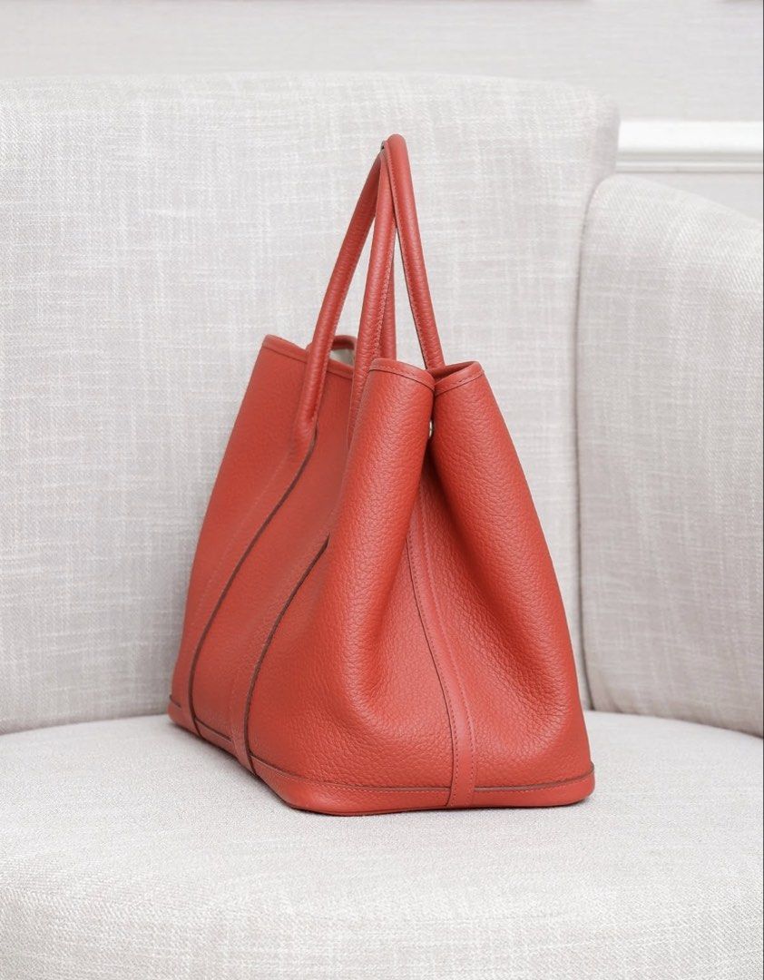 GPT 36 Rouge Venetian (Category: Tote Bags) located in Makati City. Submitted by dgcurated09 (Listing ID 1464306358, Image 2). Description: -STAMP R Stylish orange leather tote bag - Classic design with comfortable top handles - Ideal for daily use, offering plenty of space - Features a textured leather finish - Secure silver snap closure at the top.