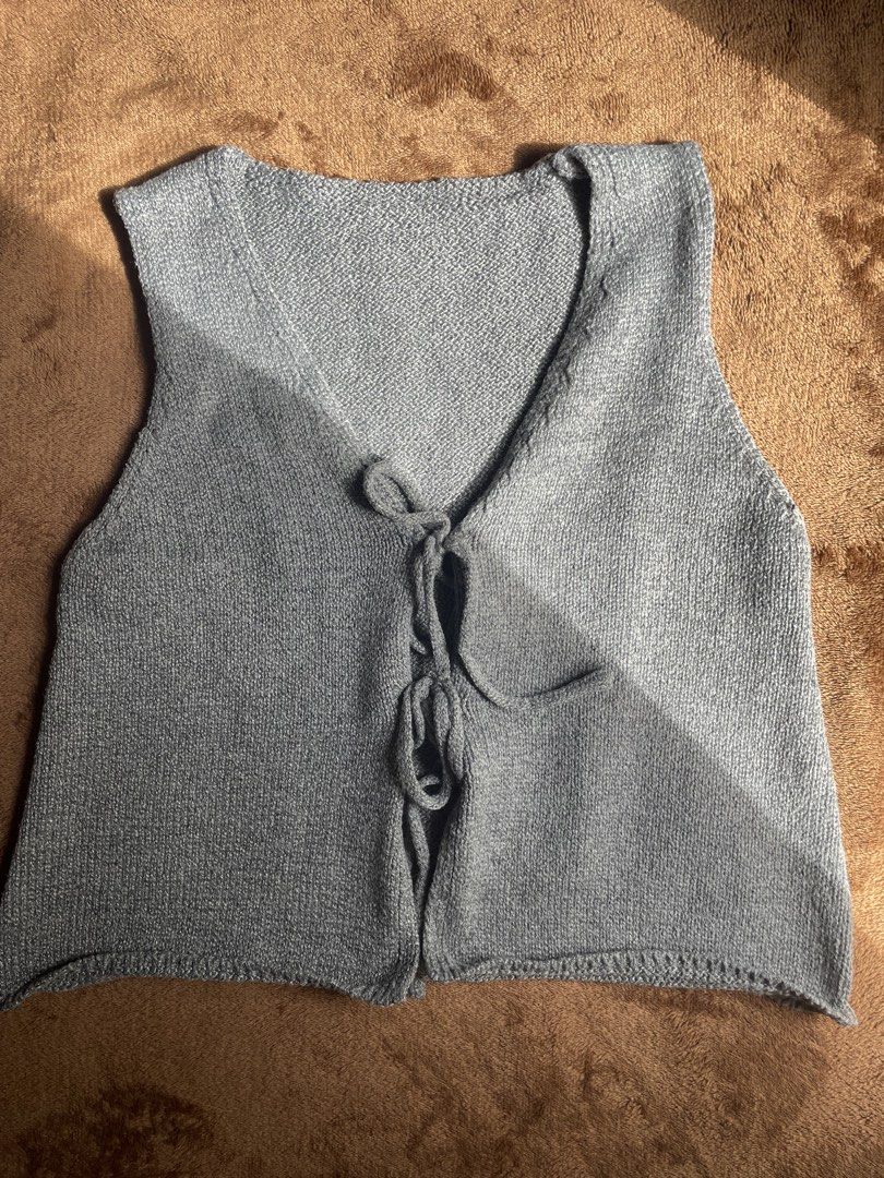 Grey Knit Lace-Up Vest (Category: Sleeveless) located in Manila. Submitted by brightdragon-5121b8 (Listing ID 1464326798, Image 1). Description: - Grey knit vest - V-neckline - Lace-up front closure with ties - Sleeveless - Textured knit fabric - Ideal for layering - Pairs well with jeans or skirts.