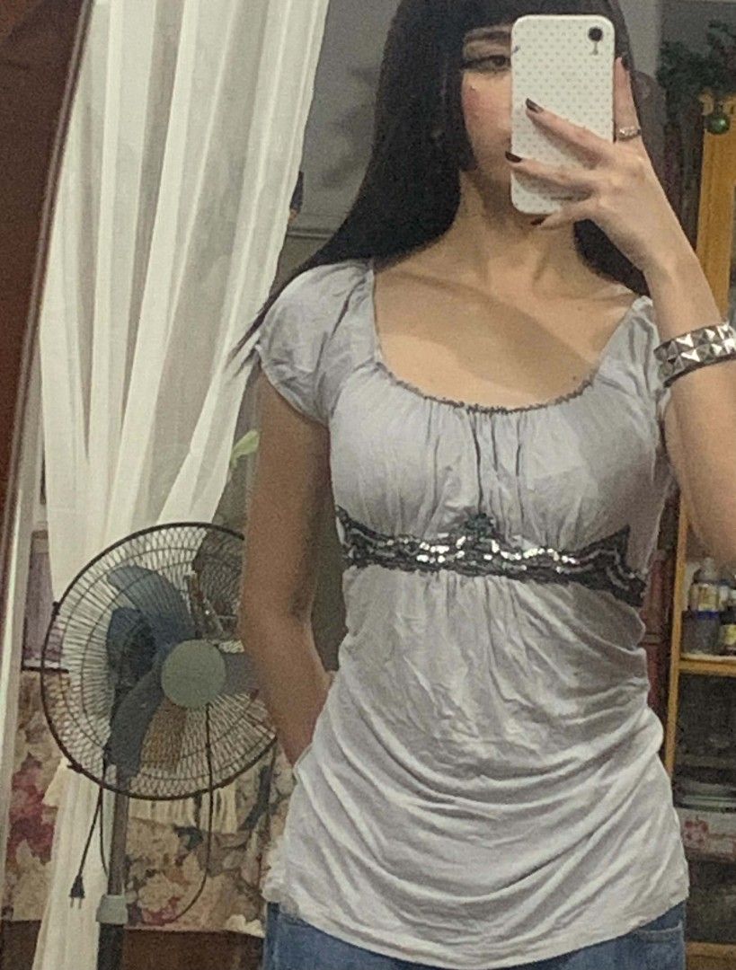 Grey Ruched Top with Beaded Embellishment (Category: Sleeveless) located in Tiaong. Submitted by cdoswan (Listing ID 1464273870, Image 3). Description: - Grey short-sleeved top - Ruched neckline detail - Decorative beaded trim across the chest - Fabric with a slight sheen - Very flattering fit - Perfect for dressing up or down.