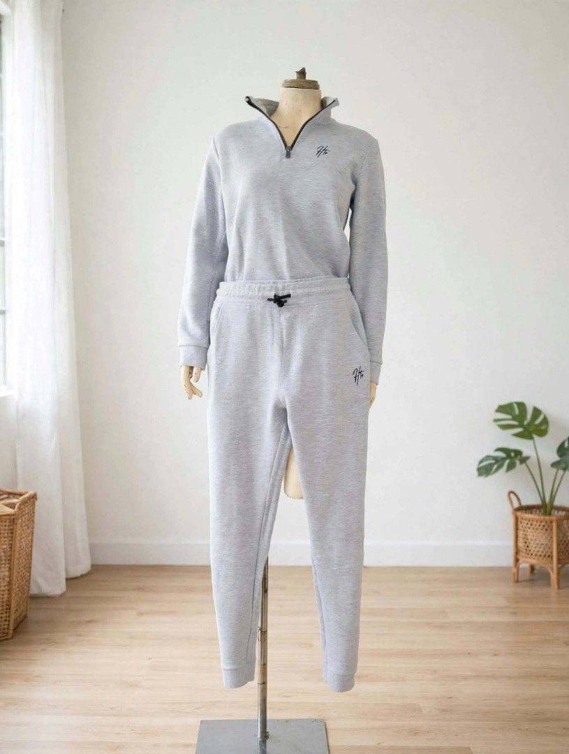 Grey Sweatshirt and Joggers Set with Logo (Category: Sets or Coordinates) located in Manila. Submitted by merry.05 (Listing ID 1464170468, Image 1). Description: - Grey quarter-zip sweatshirt and matching joggers set. - Features a small black logo on both pieces. - Comfortable and casual design, ideal for lounging or running errands. - Joggers have an elastic waistband with a drawstring for a secure fit. - Sweatshirt has long sleeves for added wa