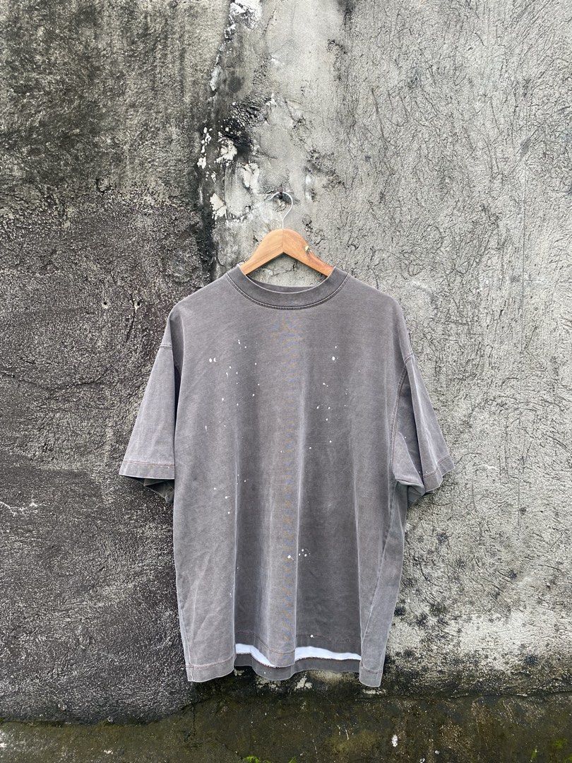 Grey T-shirt with paint splatters (Category: Shirts) located in Manila. Submitted by biggiened (Listing ID 1464216325, Image 1). Description: - Washed-out grey t-shirt - Features small white paint splatters all over - Slightly oversized fit - Layered hem detail - Perfect for an edgy, casual style.