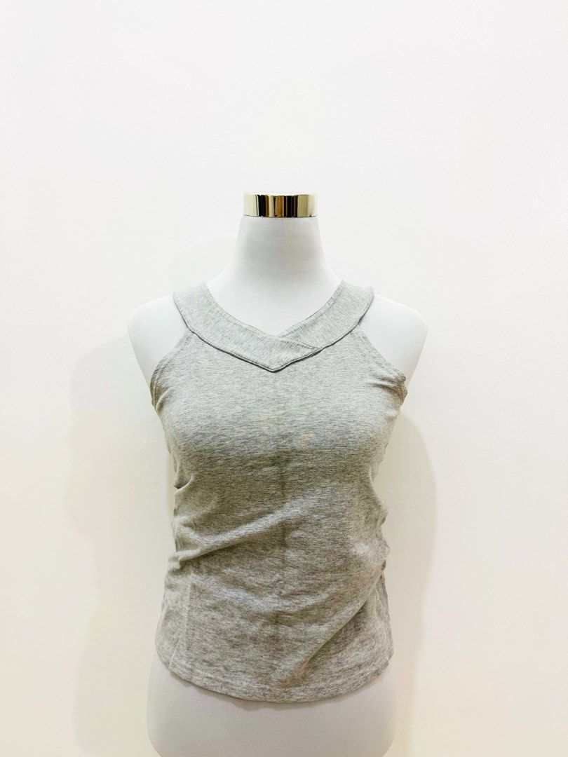 Grey V-Neck Sleeveless Tank Top (Category: Sleeveless) located in Manila. Submitted by e.louise (Listing ID 1464334438, Image 2). Description: - Simple grey tank top - Flattering V-neck design - Sleeveless style - Versatile for layering or wearing alone - Comfortable fabric - Effortlessly matches any outfit.