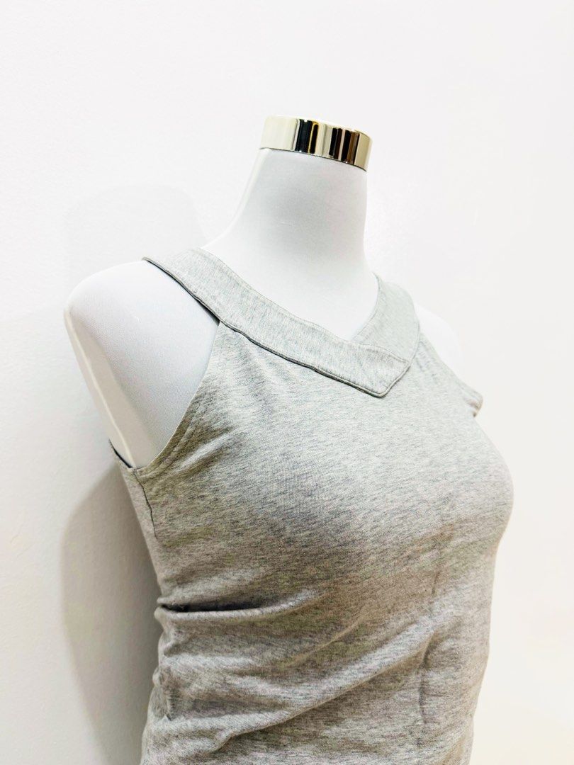 Grey V-Neck Sleeveless Tank Top (Category: Sleeveless) located in Manila. Submitted by e.louise (Listing ID 1464334438, Image 1). Description: - Simple grey tank top - Flattering V-neck design - Sleeveless style - Versatile for layering or wearing alone - Comfortable fabric - Effortlessly matches any outfit.