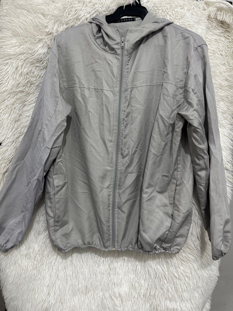 Grey Zip-Up Hooded Jacket (Category: Coats, Jackets and Outerwear) located in Imus. Submitted by nomsthriftshop (Listing ID 1464217117, Image 1). Description: - Light grey hooded jacket - Full zip-up front - Subtle textured fabric pattern - Elasticated cuffs and hem - Ideal for layering or as a light windbreaker - Easy to pack and carry.
