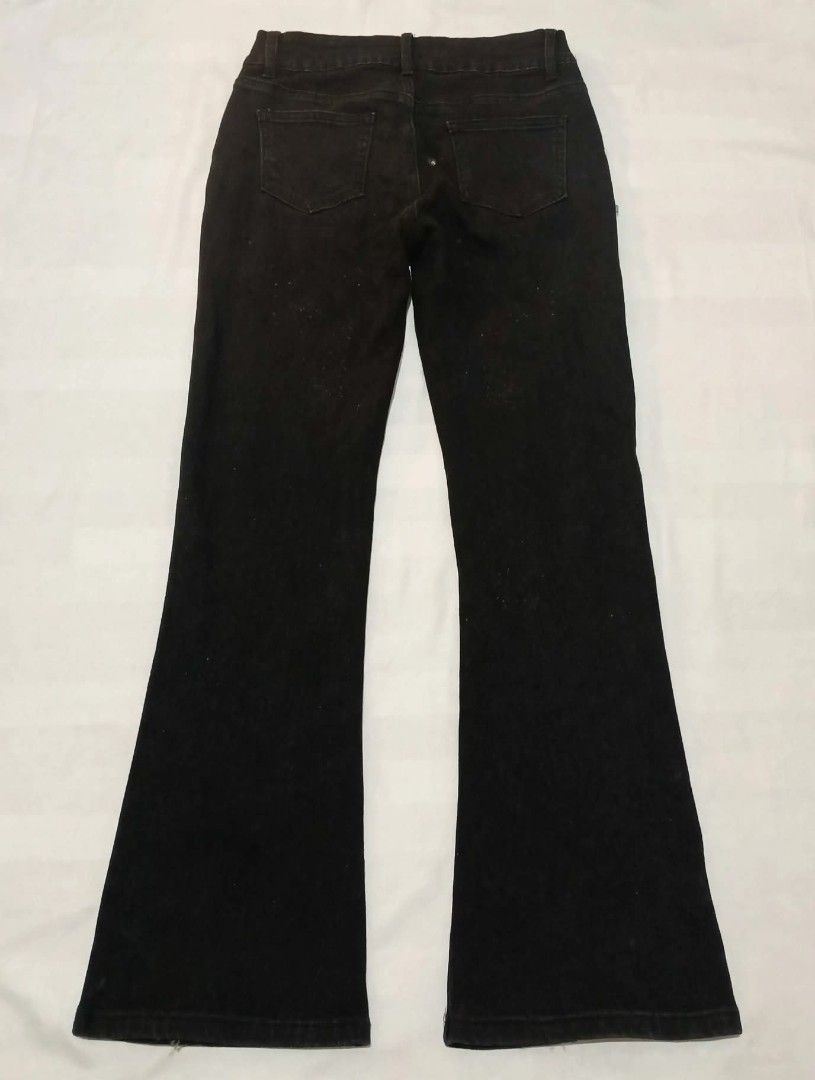 GUAYDIAN Black Flare Jeans with Split Hem (Category: Jeans) located in Manila. Submitted by angelic.clot (Listing ID 1462817597, Image 2). Description: - Brand: GUAYDIAN - Style: Black flare jeans - Fit: High-waisted - Features: Split hem with small cross detail on each leg - Versatility: Perfect for dressing up or down.