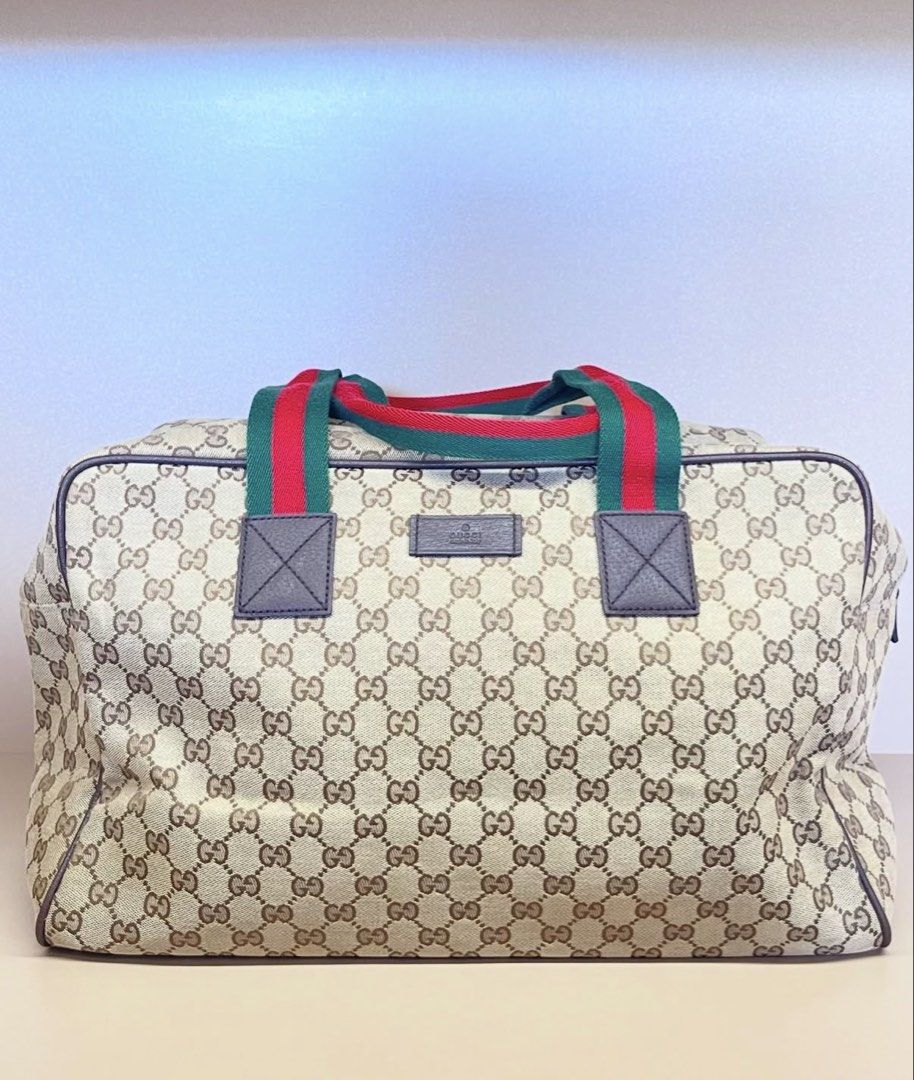 Gucci GG Monogram Canvas Duffel Bag (Category: Luxury Bags & Wallets) located in Makati City. Submitted by dgcurated09 (Listing ID 1464309194, Image 1). Description: - Authentic Gucci duffel bag - Classic GG monogram canvas - Iconic red and green stripe detail on handles - Leather trim and accents - Zipper closure - Ideal for travel or weekend getaways - Made in Italy.