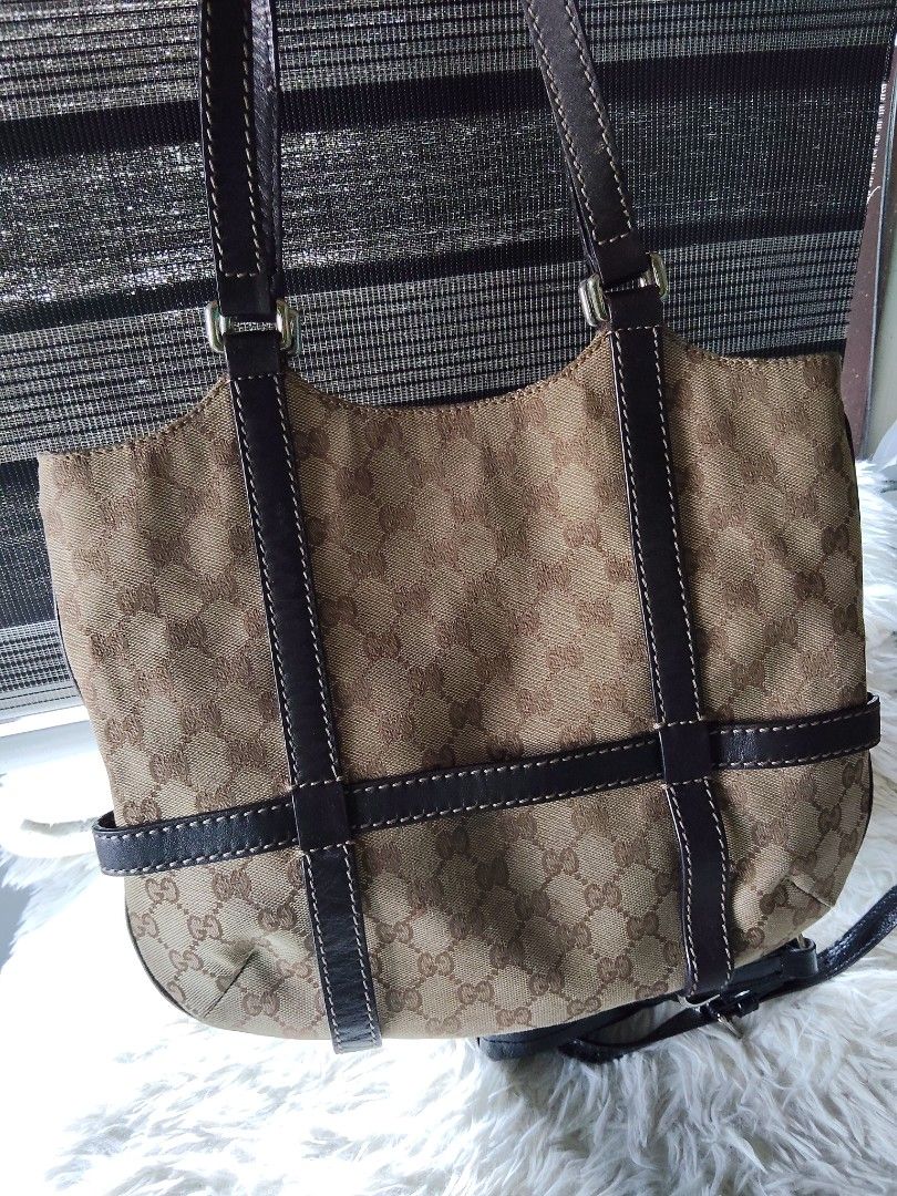 Gucci Monogram Canvas Leather Trim Shoulder Bag (Category: Luxury Bags & Wallets) located in Iba. Submitted by royalgemini (Listing ID 1464195285, Image 2). Description: - Authentic Gucci shoulder bag - Classic GG monogram canvas - Dark brown leather trim and straps - Zipper closure - Interior leather tag with serial number 181502 2123 - Made in Italy - Shows some signs of wear but still a great bag.