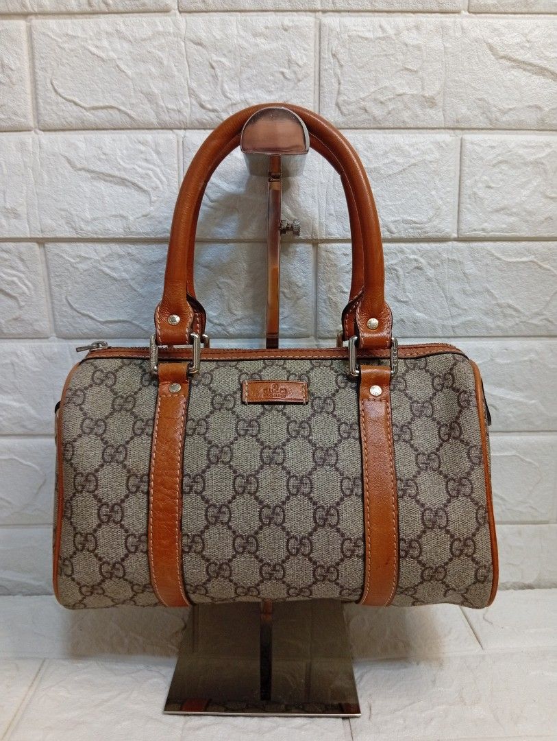 Gucci Monogram Canvas Leather Trim Boston Bag (Category: Luxury Bags & Wallets) located in Las Pinas. Submitted by etoksi1234 (Listing ID 1464196357, Image 1). Description: Pre-loved Gucci Small Joy Boston Bag, distinguished by its classic beige and ebony GG coated canvas body paired with contrasting brown rolled leather trim..