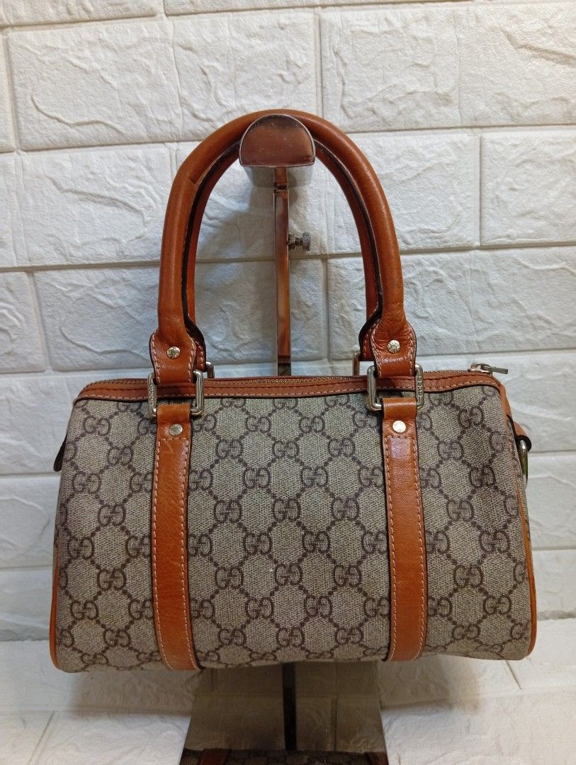 Gucci Monogram Canvas Leather Trim Boston Bag (Category: Luxury Bags & Wallets) located in Las Pinas. Submitted by etoksi1234 (Listing ID 1464196357, Image 2). Description: Pre-loved Gucci Small Joy Boston Bag, distinguished by its classic beige and ebony GG coated canvas body paired with contrasting brown rolled leather trim..