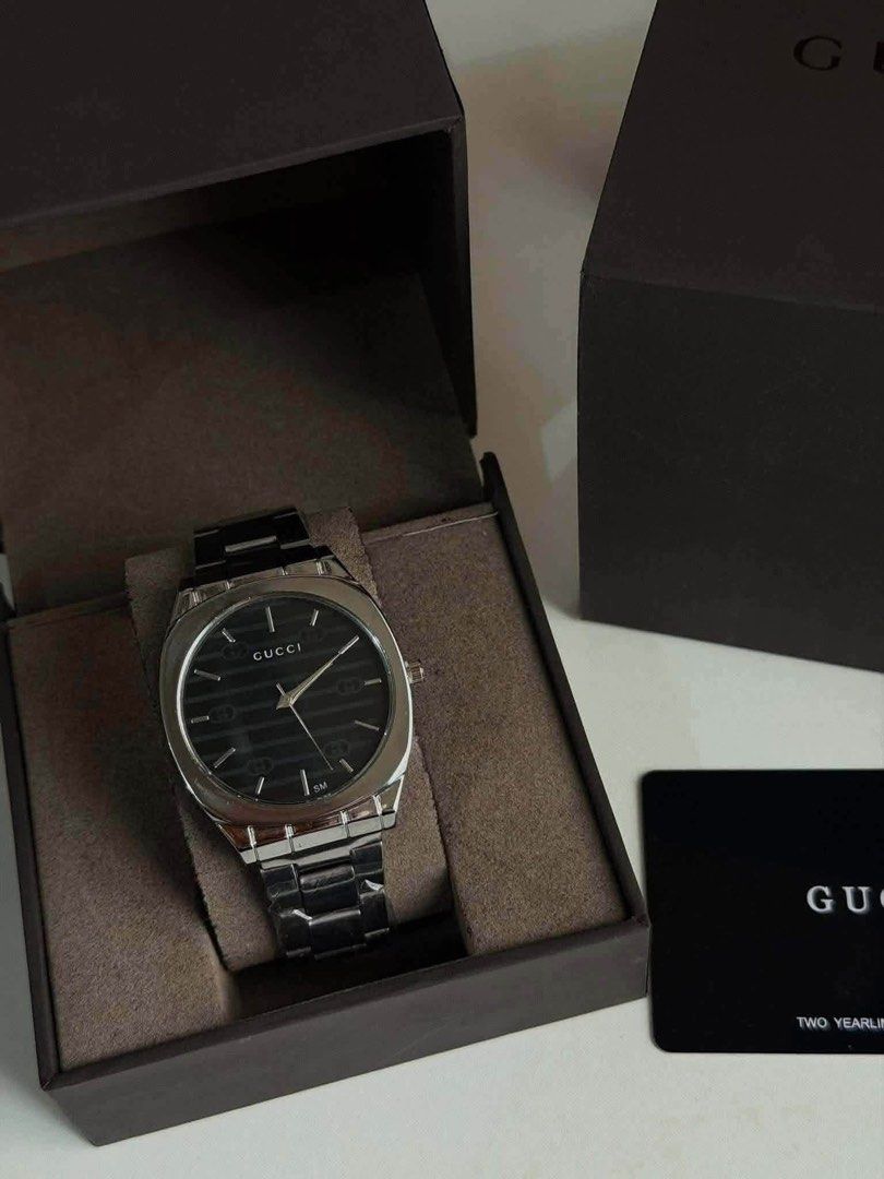 Gucci Watch (Category: Luxury Watches) located in Malabon City. Submitted by tinxoxo (Listing ID 1464327796, Image 1). Description: WITH BOX AND PAPERBAG - Gucci Watch - Classic Black Dial - Sleek Silver Metal Strap - Comes with Original Box - Includes Warranty Card - Water Resistant up to 50 Meters - Ideal for Everyday Wear.