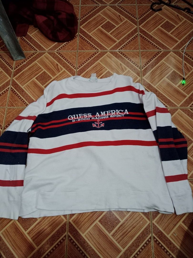 Guess Kids Logo Sweatshirt (Category: Babies & Kids Fashion) located in Naga. Submitted by thrift.vincent (Listing ID 1464168535, Image 1). Description: Snag this Farfetch kids logo sweatshirt in size M. It’s got a classic white look with navy and red stripes and a cozy fleece-like interior. Features include the Guess America G-2000 Racing Spirit embroidery, a red anchor detail, and ribbed trim. It's an 80% cotton and 20% polyester blend. Note th