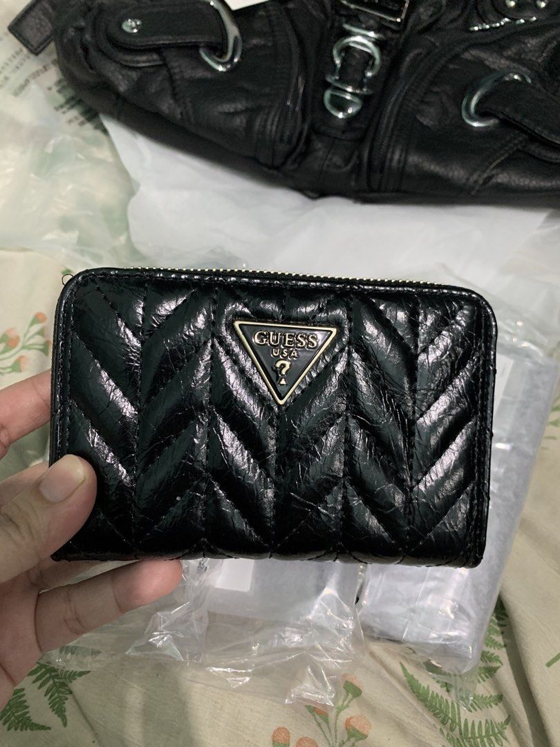 Guess Quilted Zip Around Wallet Black (Category: Wallets & Card holders) located in Manila. Submitted by apraeltrends (Listing ID 1464209644, Image 1). Description: - Stylish black Guess wallet - Elegant quilted chevron pattern - Secure zip-around closure - Multiple interior card slots - Convenient zippered coin pocket - Chic gold-tone hardware - Compact size: approximately 4.5" x 3.5".