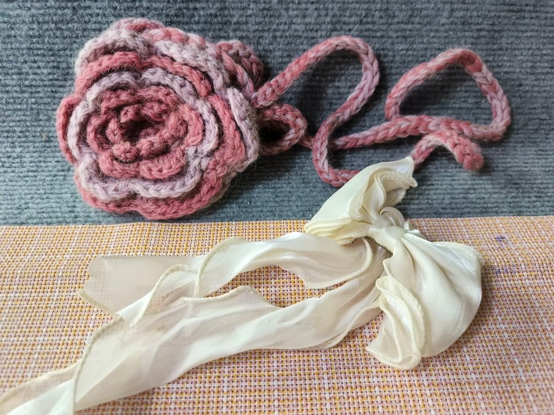Handmade Crocheted Rose Bag with Ribbon (Category: Shoulder Bags) located in San Leonardo. Submitted by burgossanleonardo.12345 (Listing ID 1464182115, Image 2). Description: - Cute crocheted bag shaped like a rose. - Made with pink and white yarn. - Features a braided strap. - Adorned with a delicate cream ribbon bow. - Small size, perfect for coins or small trinkets. - Unique, handmade item. - Great for gifting or personal use..
