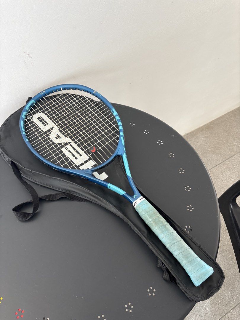 HEAD Elite Tennis Racket with Cover (Category: Racket and Ball Sports) located in Quezon City. Submitted by mynameismio (Listing ID 1464161059, Image 1). Description: - Blue HEAD Elite tennis racket - Includes black racket cover - Light blue grip with minor signs of use - Ready for the court.