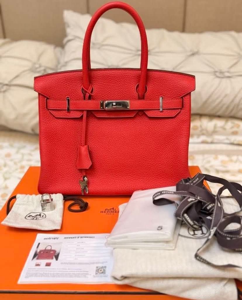 Hermes Birkin Red Taurillon Clemence Leather (Category: Luxury Bags & Wallets) located in Manila. Submitted by rufus_apparel (Listing ID 1464302579, Image 2). Description: - Authentic Hermes Birkin Bag - Color: Red - Leather: Taurillon Clemence - Authenticity: Entrupy Certificate Included - Accessories: Dust bag, lock, keys, box - Hardware: Silver-tone - A classic and timeless piece.
