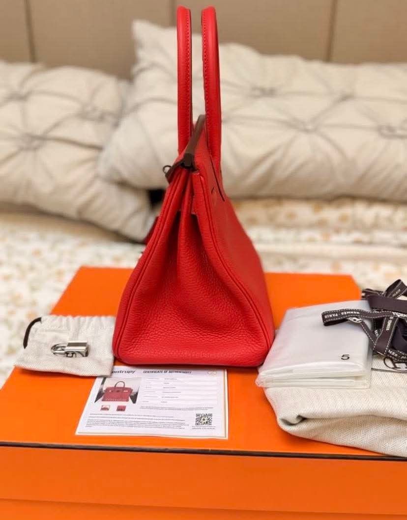 Hermes Birkin Red Taurillon Clemence Leather (Category: Luxury Bags & Wallets) located in Manila. Submitted by rufus_apparel (Listing ID 1464302579, Image 3). Description: - Authentic Hermes Birkin Bag - Color: Red - Leather: Taurillon Clemence - Authenticity: Entrupy Certificate Included - Accessories: Dust bag, lock, keys, box - Hardware: Silver-tone - A classic and timeless piece.