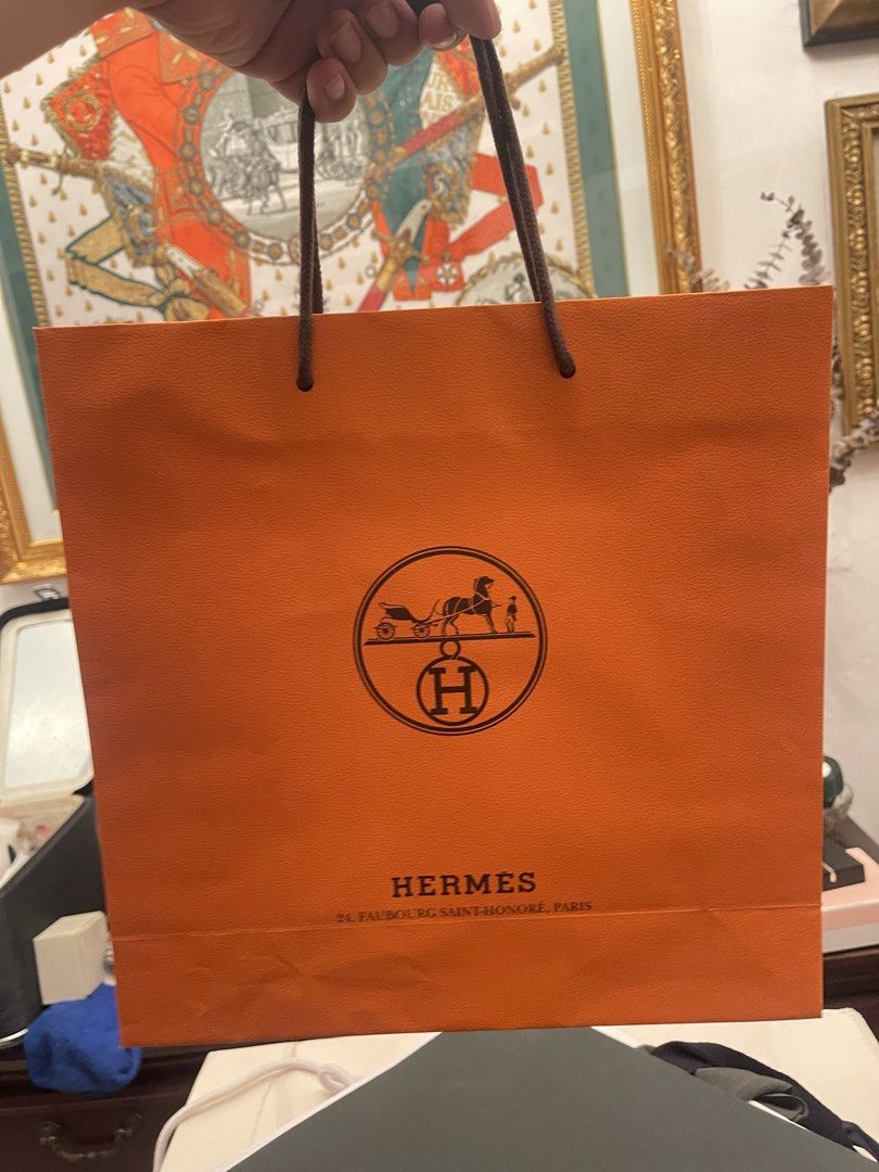 Hermes Shopping Bag (Category: Tote Bags) located in Marilao. Submitted by wardrovearchives (Listing ID 1464250662, Image 1). Description: - Authentic Hermes shopping bag - Iconic orange color - Features the classic horse and carriage logo - Address detail: 24, Faubourg Saint-Honoré, Paris - Ideal for storing or gifting luxury items - A timeless piece from a luxury brand.