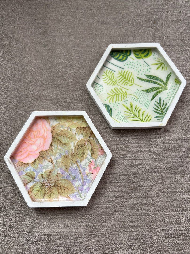 Hexagon Resin Coaster - Botanical Design (Category: Dinnerware & Cutlery) located in Quezon City. Submitted by hygge.elements (Listing ID 1464162607, Image 1). Description: 1 pc Handmade hexagon coaster - Design 1: Beautiful pink rose and floral pattern. - Design 2: Vibrant green leaf design. - Protects your furniture from drink stains - Holds your fave trinkets or jewelry - Adds a touch of unique decor to any room. - Perfect as a thoughtful gift
