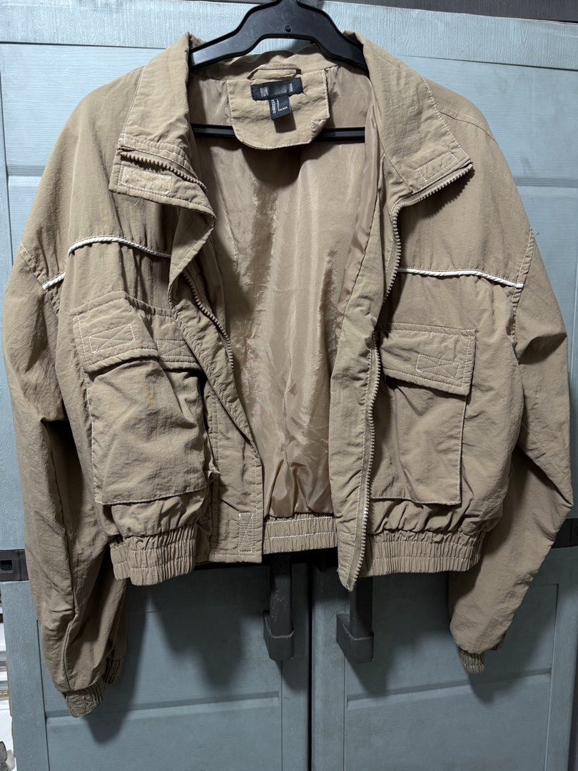 Forever 21 Cropped Bomber Jacket Khaki Size L (Category: Coats, Jackets and Outerwear) located in Manila. Submitted by aprilled (Listing ID 1464255303, Image 2). Description: - Khaki Cropped Bomber Jacket - Features a high collar - Elasticated cuffs and hem for a snug fit - Two large front pockets with button closure - Zip-up front - Ideal for layering - Pairs well with jeans or leggings.