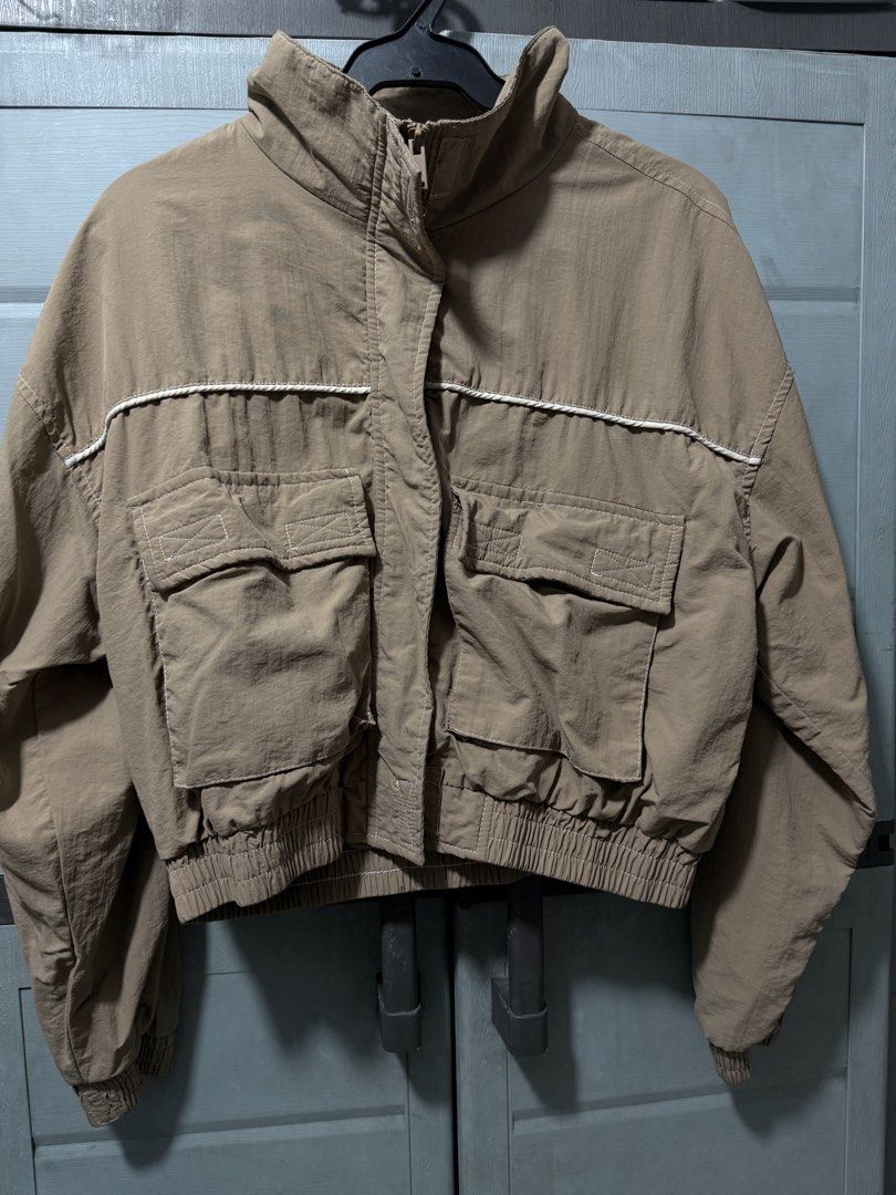 Forever 21 Cropped Bomber Jacket Khaki Size L (Category: Coats, Jackets and Outerwear) located in Manila. Submitted by aprilled (Listing ID 1464255303, Image 1). Description: - Khaki Cropped Bomber Jacket - Features a high collar - Elasticated cuffs and hem for a snug fit - Two large front pockets with button closure - Zip-up front - Ideal for layering - Pairs well with jeans or leggings.