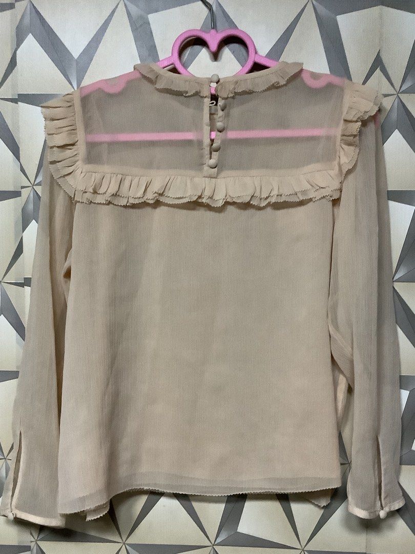H&M Dusty Peach Sheer Ruffle Chiffon Blouse (Category: Blouses) located in Quezon City. Submitted by lovedbyerara (Listing ID 1464271684, Image 2). Description: Design Details: A romantic, vintage-inspired blouse featuring layered pleated ruffles arranged horizontally across the upper chest and accenting the shoulders. It is designed with a mock-neckline trimmed with a subtle mini-frill, long flowing sleeves, and a clean finished hem. Material & 