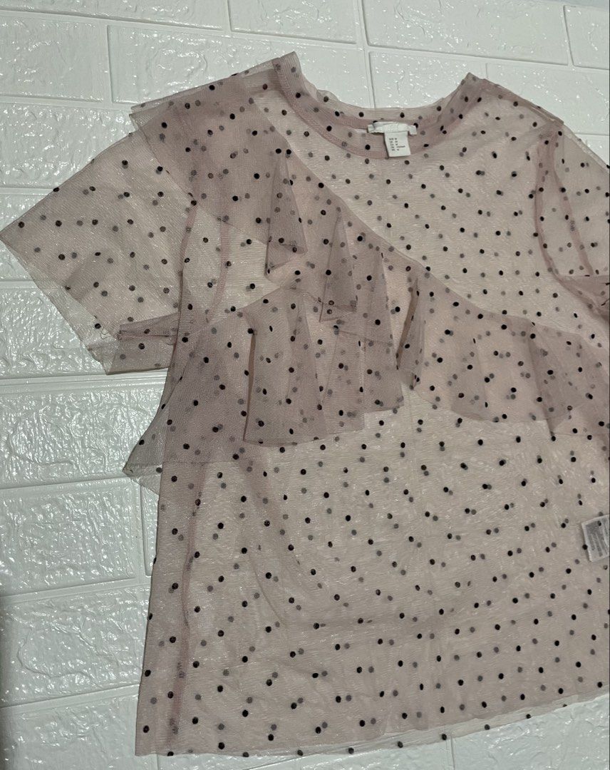 H&M Sheer Mesh Polka Dot Ruffle Top (Category: Shirts) located in Marilao. Submitted by clear_out_closet (Listing ID 1464291315, Image 2). Description: Item Details: 👇 • Brand: H&M • Color: Light Pink with Black Polka Dots • Material: 100% Polyester • Country of Origin: Made in Turkey • Sizing: Tagged Size EUR M / US M / CA M / CN 170/96A / MX M • Condition Note: Excellent pre-loved condition with clean sheer mesh fabric, no visible snags, and i