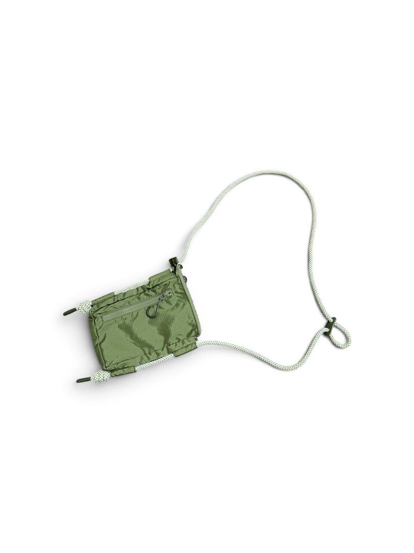 Hunter Green Nylon Pouch with Rope Strap (Category: Sling Bags) located in Nabua. Submitted by lastthrift2.0 (Listing ID 1464241702, Image 2). Description: •Good as new condition - Hunter olive green pouch - Made from durable nylon with a textured finish - Features a secure zippered main compartment - Includes a convenient detachable rope strap - Small and compact, ideal for carrying your essentials - Labeled as made with recycled materials.