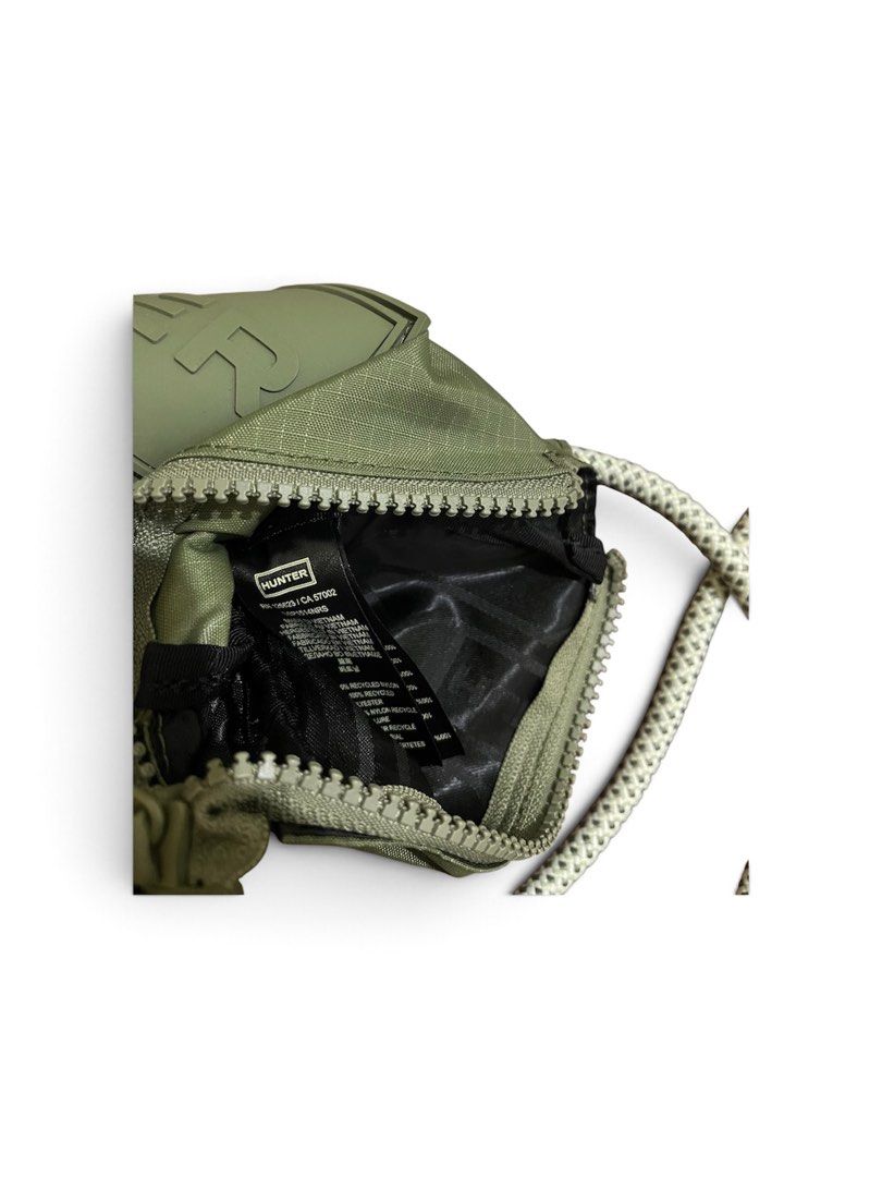 Hunter Green Nylon Pouch with Rope Strap (Category: Sling Bags) located in Nabua. Submitted by lastthrift2.0 (Listing ID 1464241702, Image 3). Description: •Good as new condition - Hunter olive green pouch - Made from durable nylon with a textured finish - Features a secure zippered main compartment - Includes a convenient detachable rope strap - Small and compact, ideal for carrying your essentials - Labeled as made with recycled materials.