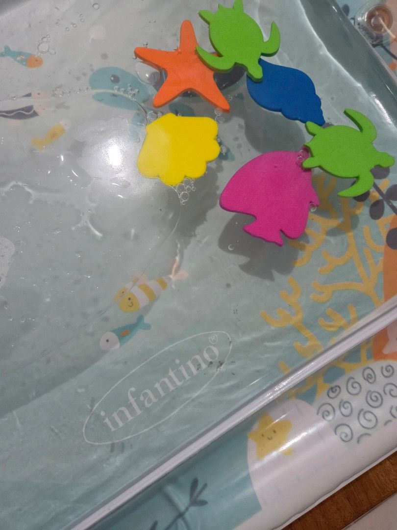 Infantino Tummy Time Water Play Mat (Category: Infant Playtime) located in Taguig. Submitted by bbbautista (Listing ID 1464199421, Image 3). Description: Fun tummy time water mat for babies. Features cute sea creatures like a penguin and a turtle. Includes floating sea toys for little ones to interact with. Helps with sensory development and motor skills. Easy to fill with water and air. Great for keeping baby entertained. Rfs decluterring baby t
