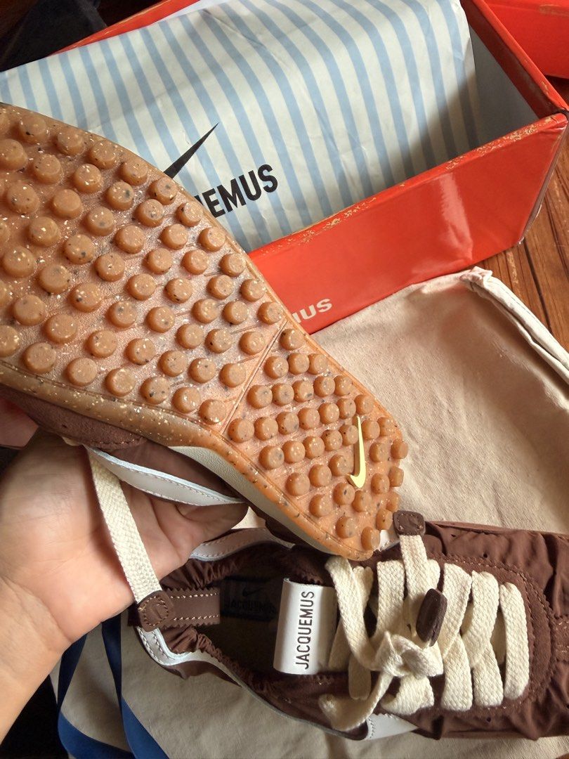 Jacquemus x Nike Brown Sneakers (Category: Sneakers) located in Las Pinas. Submitted by twiceloved24 (Listing ID 1464176623, Image 3). Description: SIZES AVAILABLE - Unique gathered nylon upper with stylish white accents. - Cream laces for a clean finish. - Distinctive textured sole for added grip and style. - Comes complete with original box and dust bag..