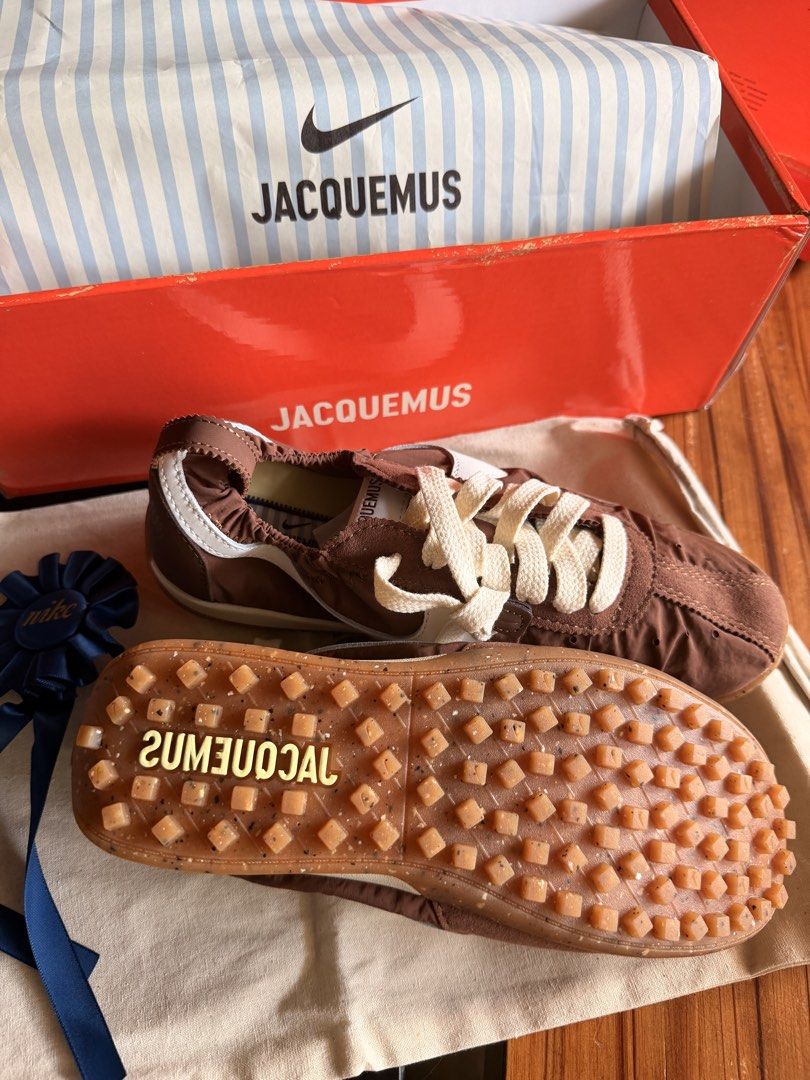 Jacquemus x Nike Brown Sneakers (Category: Sneakers) located in Las Pinas. Submitted by twiceloved24 (Listing ID 1464176623, Image 2). Description: SIZES AVAILABLE - Unique gathered nylon upper with stylish white accents. - Cream laces for a clean finish. - Distinctive textured sole for added grip and style. - Comes complete with original box and dust bag..