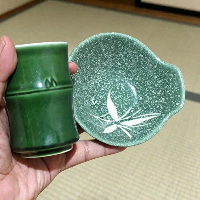 Japanese Bamboo Sake Cup and Dish Set (Category: Coffee & Tea Tableware) located in Iligan City. Submitted by sariranaw (Listing ID 1464245212, Image 1). Description: - Unique green sake cup and matching dish set. - Cup features a distinctive bamboo shape. - Dish has a speckled green finish with an elegant white leaf design. - Ideal for serving sake or as small dipping bowls. - Adds a unique touch to your table setting..