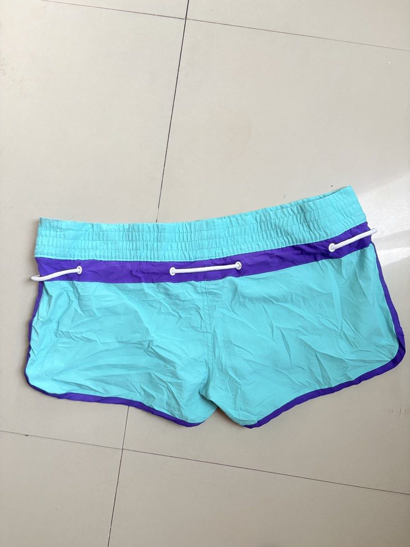 Joe boxer swim shorts (Category: Shorts) located in Binangonan. Submitted by polinn.xx (Listing ID 1464205259, Image 3). Description: Vibrant turquoise and purple Joe Boxer swim shorts feature a contrasting white drawstring and distinct side branding. Waistline: 34-36.