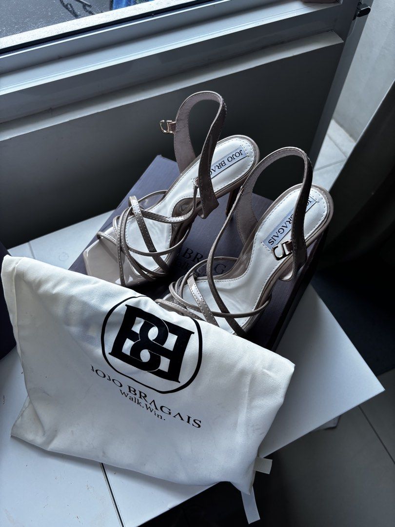 Jojo Bragais Strappy Heels MMD Version (Category: Heels) located in Paranaque City. Submitted by aryanista (Listing ID 1464202039, Image 2). Description: - Brand: Jojo Bragais - Color: Beige - Material: Patent Leather - Style: Strappy Heels - Features: Criss-cross straps, ankle strap with buckle closure, square toe - Size: 7.5 - Includes: Original box and dust bag LOC Makati.