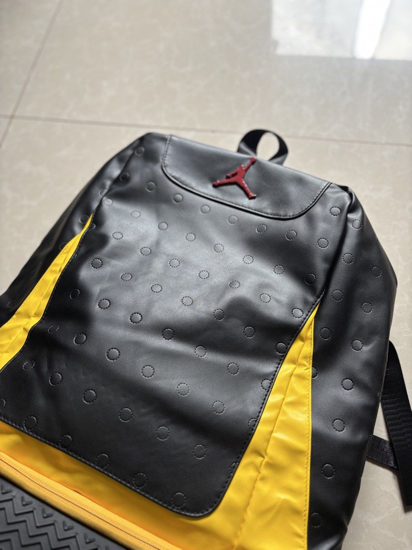 Jordan Backpack Black Yellow Jumpman Logo (Category: Backpacks) located in Quezon City. Submitted by nojthrift (Listing ID 1464250446, Image 2). Description: - Stylish black Jordan backpack with eye-catching yellow accents. - Unique circle details on the front for a standout look. - Comfortable padded straps for easy carrying. - Convenient separate compartment at the bottom, ideal for shoes or wet gym clothes. - Versatile and practical for school