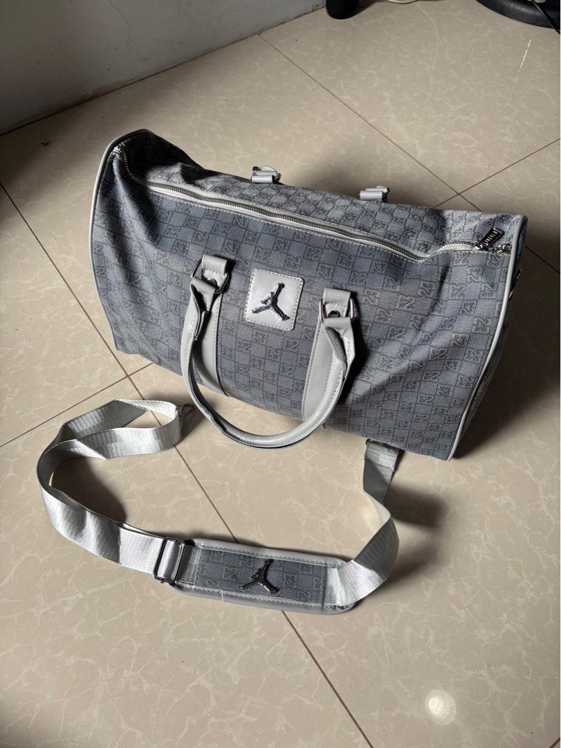 Jordan Grey Monogram Duffel Bag (Category: Luxury Bags & Wallets) located in Quezon City. Submitted by nojthrift (Listing ID 1464253261, Image 1). Description: - Grey Jordan duffel bag - All-over monogram print - Dual top handles - Detachable shoulder strap - Zip main compartment - Interior zip pocket - Ideal for gym or travel.