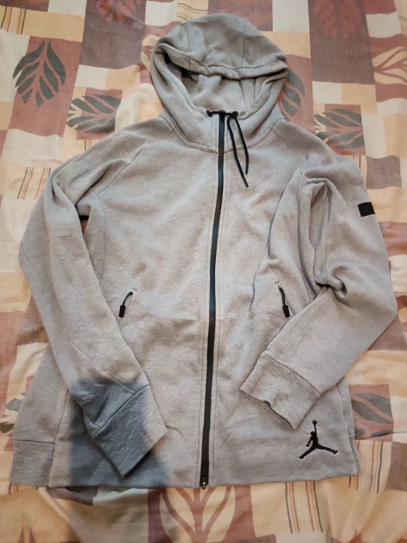 Jordan jacket (Category: Activewear) located in Odiongan. Submitted by thriftngo26 (Listing ID 1464161603, Image 1). Description: This is a grey Jordan full-zip hoodie featuring a distinctive black Jumpman logo near the lower left.