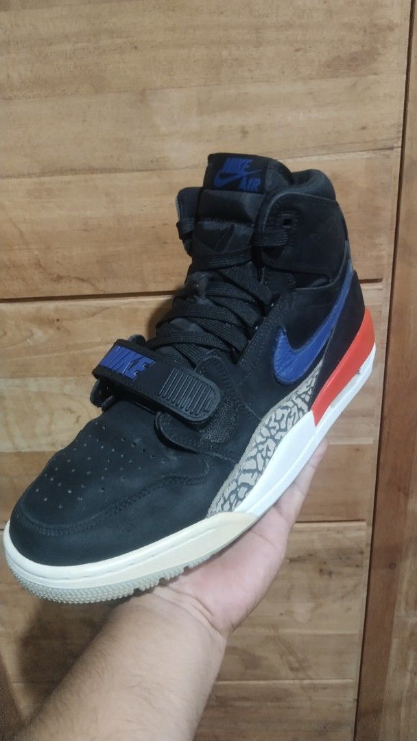 Jordan Legacy 312 High Cut Knicks (Category: Sneakers) located in Manila. Submitted by bigbenplaysthriftstore (Listing ID 1464294034, Image 3). Description: - Black high-top sneakers - Blue and red accent details - Iconic elephant print on the midsole - Adjustable midfoot strap with Nike branding - Jordan branding on heel and sole - Ideal for casual wear or playing basketball.