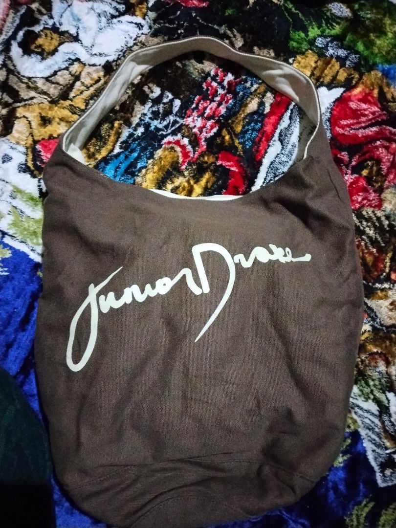 Junior Drake Hobo Bag (Category: Cross-body Bags) located in Mabalacat. Submitted by al_amin_thrift (Listing ID 1464253108, Image 1). Description: Junior Drake Reversible Canvas Hobo Bag Brand: Junior Drake Style: Reversible hobo / shoulder bag — 2 looks in 1! Details: - Side 1: Rich brown canvas with cream "Junior Drake" signature print + cream trim ​ - Side 2: Soft cream canvas with brown signature print + brown trim ​ - Spacious, slouchy shape