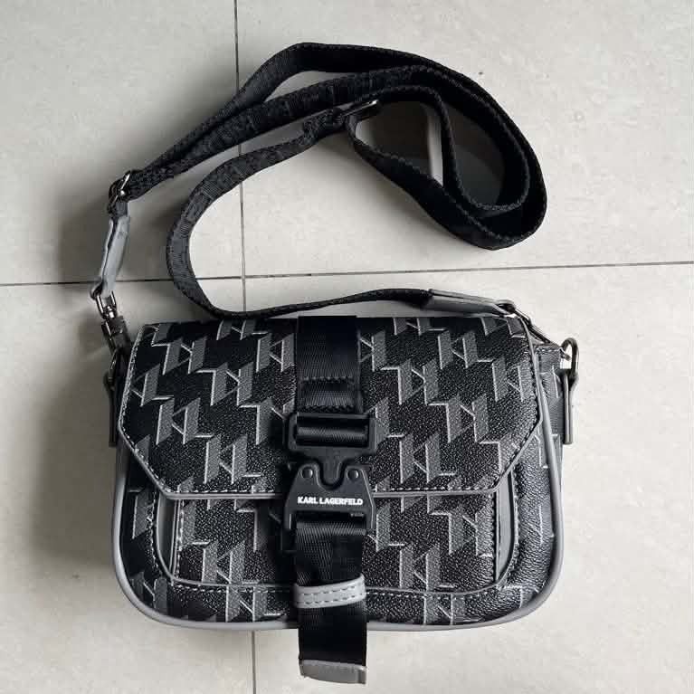 Karl Lagerfeld Monogram Crossbody Bag (Category: Cross-body Bags) located in Cavite. Submitted by mahthriftshop (Listing ID 1464265249, Image 2). Description: -Singapore mop gcash+sf - Karl Lagerfeld crossbody bag - Features all-over KL monogram pattern - Secure buckle closure on front flap - Adjustable strap with Karl Lagerfeld branding - Interior zip pocket for essentials - Ideal for everyday use.