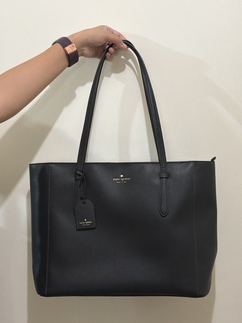 Kate Spade Black Leather Tote Bag (Category: Tote Bags) located in Quezon City. Submitted by kiki.finds (Listing ID 1464223811, Image 1). Description: - Classic black tote bag from Kate Spade New York - Secure zip top closure - Spacious interior for essentials - Ideal for work or everyday use - Got it as a gift, not my style - Stored only, never used.