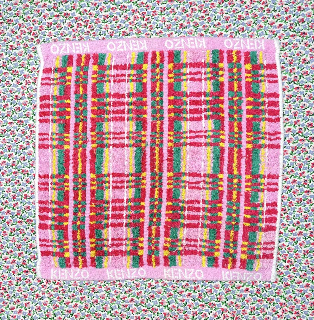 Kenzo Pink Plaid Towel (Category: Bedding & Towels) located in Pakil. Submitted by roserarela (Listing ID 1464269886, Image 1). Description: - Pink towel with red, green, and yellow plaid pattern - Features Kenzo logo on top and bottom edges - Soft and absorbent material - Perfect for everyday use or as a decorative item A vintage KENZO plaid cotton mini towel or handkerchief featuring a bright pink, green, and yellow tartan pattern with embroide
