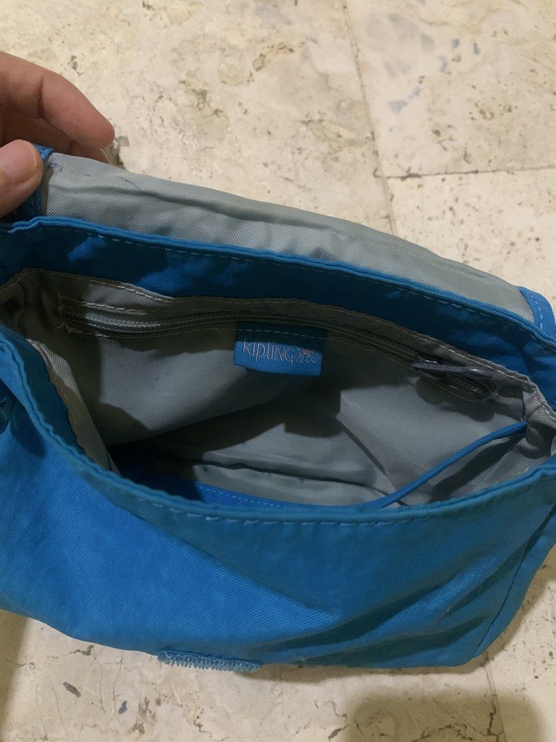 Kipling (Category: Cross-body Bags) located in Quezon City. Submitted by marjoretz (Listing ID 1464180825, Image 3). Description: For Sale: Kipling Sling/Crossbody Bag 💙 Kipling crossbody/sling bag in a beautiful blue/turquoise color. ✨ Original Kipling ✨ Adjustable long strap ✨ Multiple compartments with zip closure ✨ Comes with the Kipling monkey keychain ✨ Lightweight and practical ✨ Perfect for everyday use or travel ✨ Pre-loved, with visibl