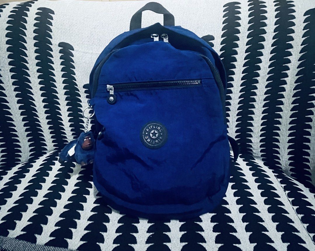 Kipling Blue Backpack with Monkey Charm (Category: Backpacks) located in Quezon City. Submitted by dressuposhoppe (Listing ID 1464208385, Image 3). Description: - Blue Kipling backpack - Features a front zip pocket and main compartment - Comes with the signature Kipling monkey charm - Durable material, easy to carry - Ideal for everyday use or travel.