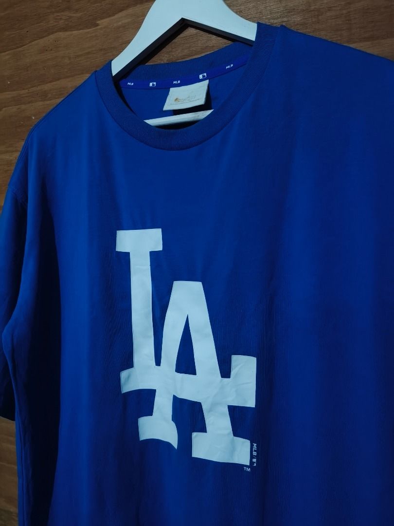 LA Dodgers MLB Blue T-Shirt (Category: Tshirts & Polo Shirts ) located in Cotabato. Submitted by grandwolf-98e8 (Listing ID 1464277305, Image 2). Description: - Official MLB LA Dodgers Blue T-Shirt - Features the iconic 'LA' graphic on the front - Comfortable and casual wear - Ideal for any baseball fan - Great for everyday use.