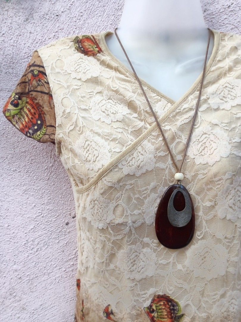 Lace Overlay Dress with Fish Print (Category: Dresses) located in Placer. Submitted by whimsythrifts (Listing ID 1464205306, Image 2). Description: - Cream lace overlay dress - Short sleeves with a unique fish print - V-neck wrap style - Hem features fish print and lace detail - Includes a long pendant necklace - Unique and eye-catching design - Ideal for casual wear.