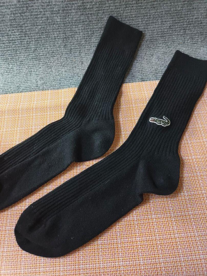 Lacoste Black Ribbed Socks with Crocodile Logo (Category: Socks) located in San Leonardo. Submitted by burgossanleonardo.12345 (Listing ID 1464188468, Image 2). Description: - Classic black ribbed socks from Lacoste. - Features the iconic embroidered green crocodile logo. - Comfortable and stylish for everyday wear. - Good length for casual or athletic use. - A wardrobe staple..