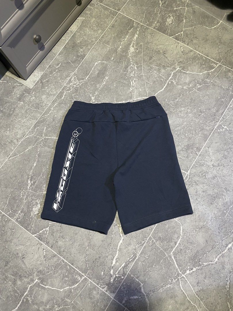Lacoste Navy Blue Graphic Shorts (Category: Shorts) located in Buenavista. Submitted by ivoperez27 (Listing ID 1464308897, Image 3). Description: - Navy blue Lacoste shorts - Bold white graphic design on the side - Smaller graphics on the front - Elastic waistband with drawstring - Comfortable fit for everyday wear - Perfect for casual outings - 30-34 waistline - 19 length -9.7/10 colorate - issue see last picture (black dots)(minimal hairline).